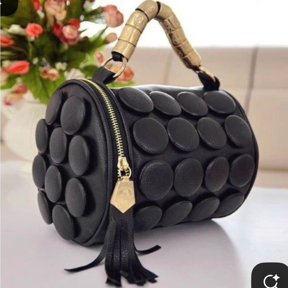 faux-leather cylinder handbag button details metal handle tassel zipper pull